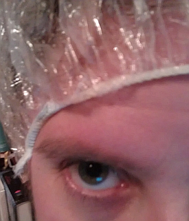 Covering my hair with a shower cap.